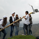 Student volunteers erect a lamp.